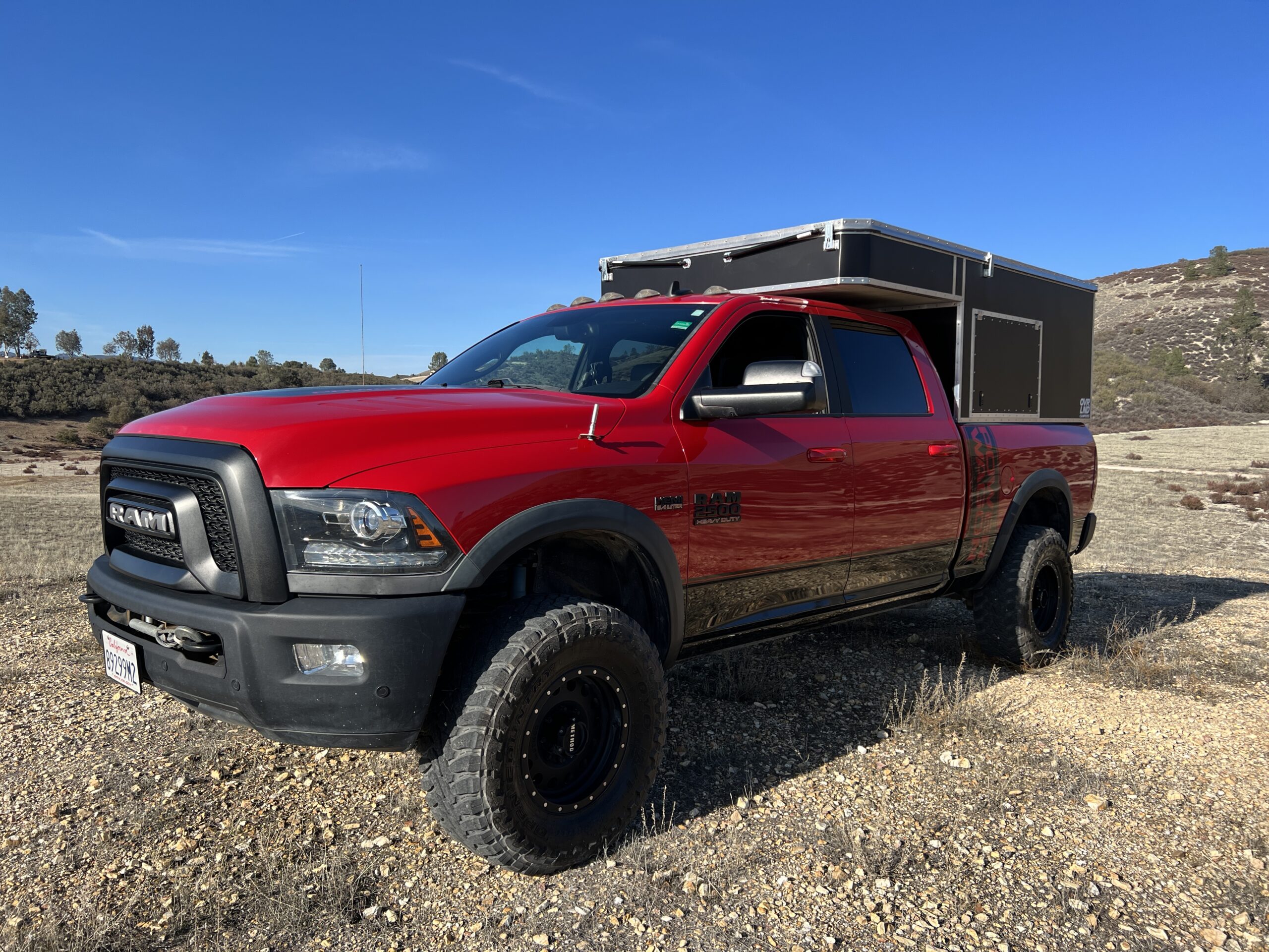 Red Power Wagon truck with OVRLND Campers popup camper shell fitted.